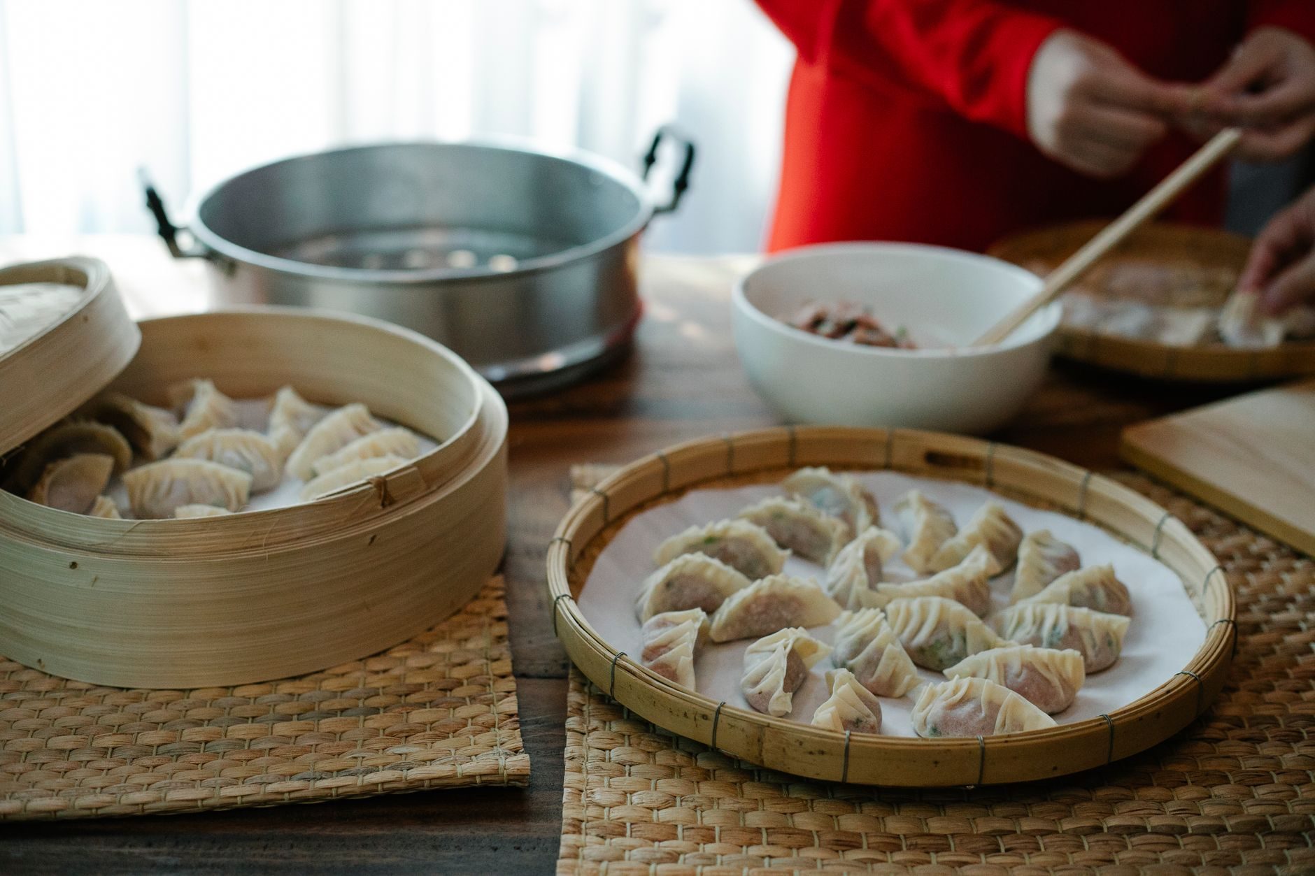 jiaozi na parze w koszyku i miseczka octu z chili