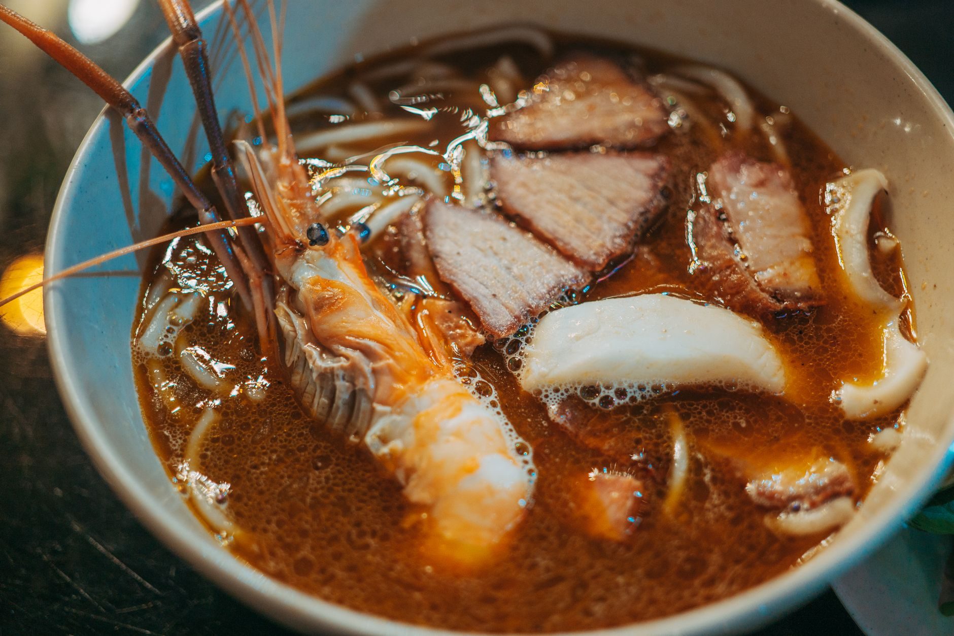 talerz smażonego hokkien mee w ciemnym sosie z krewetkami i skwarkami